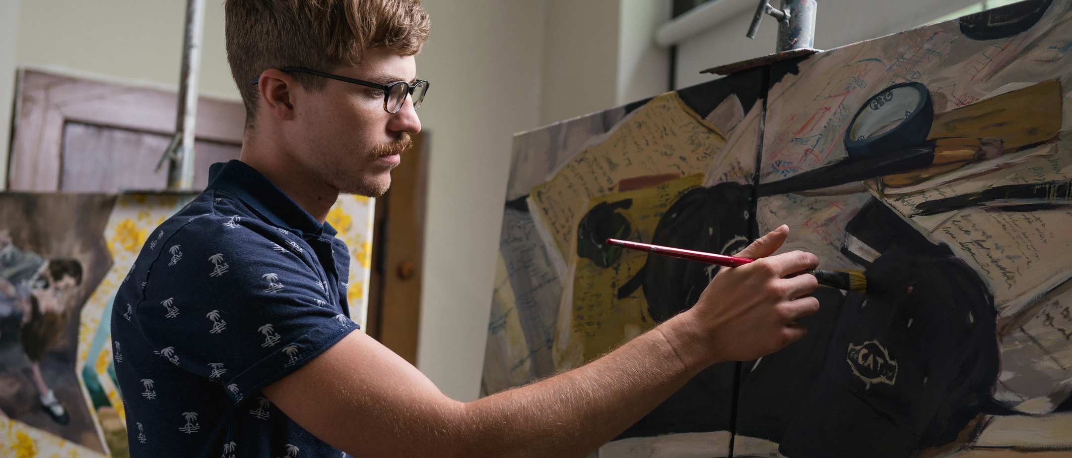 A painting student works in a master's degree course at Pennsylvania Western University (PennWest)