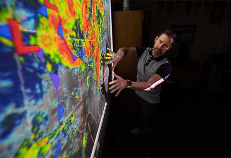 Professor teaching in front of a projector