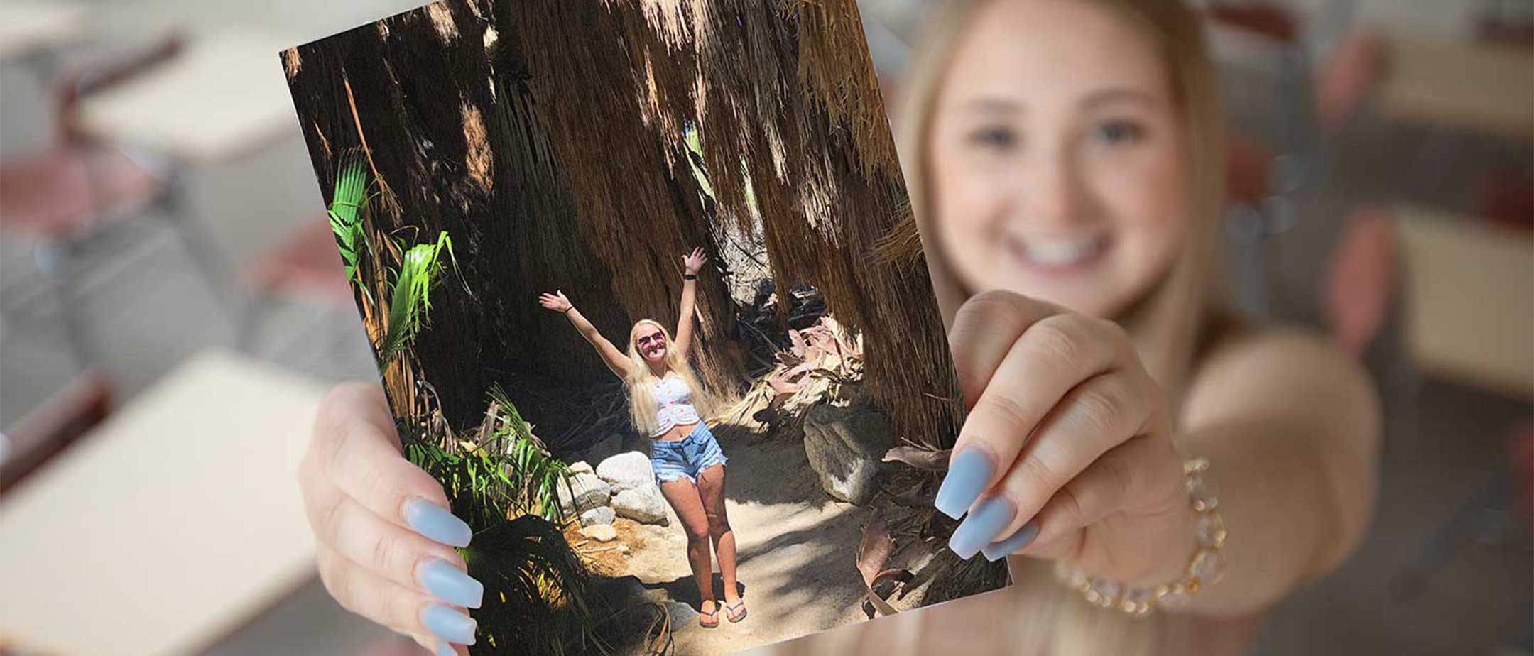 Student holding a picture of herself