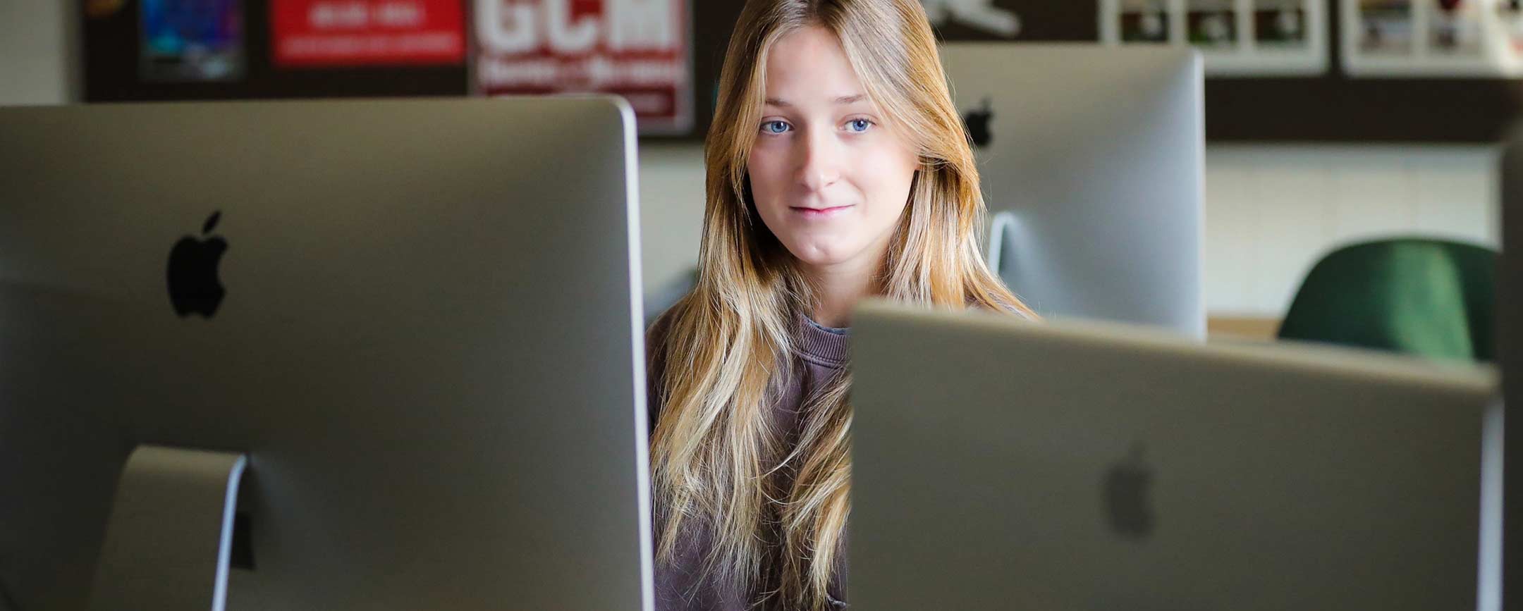 A student sitting in a computer lab