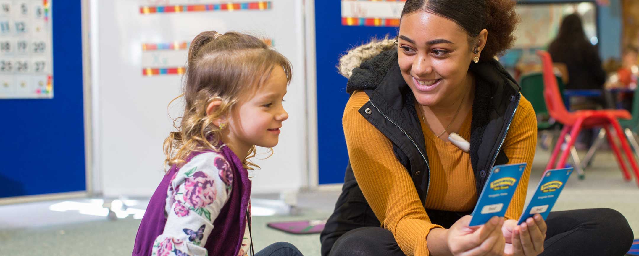 A PennWest graduate works with a child.