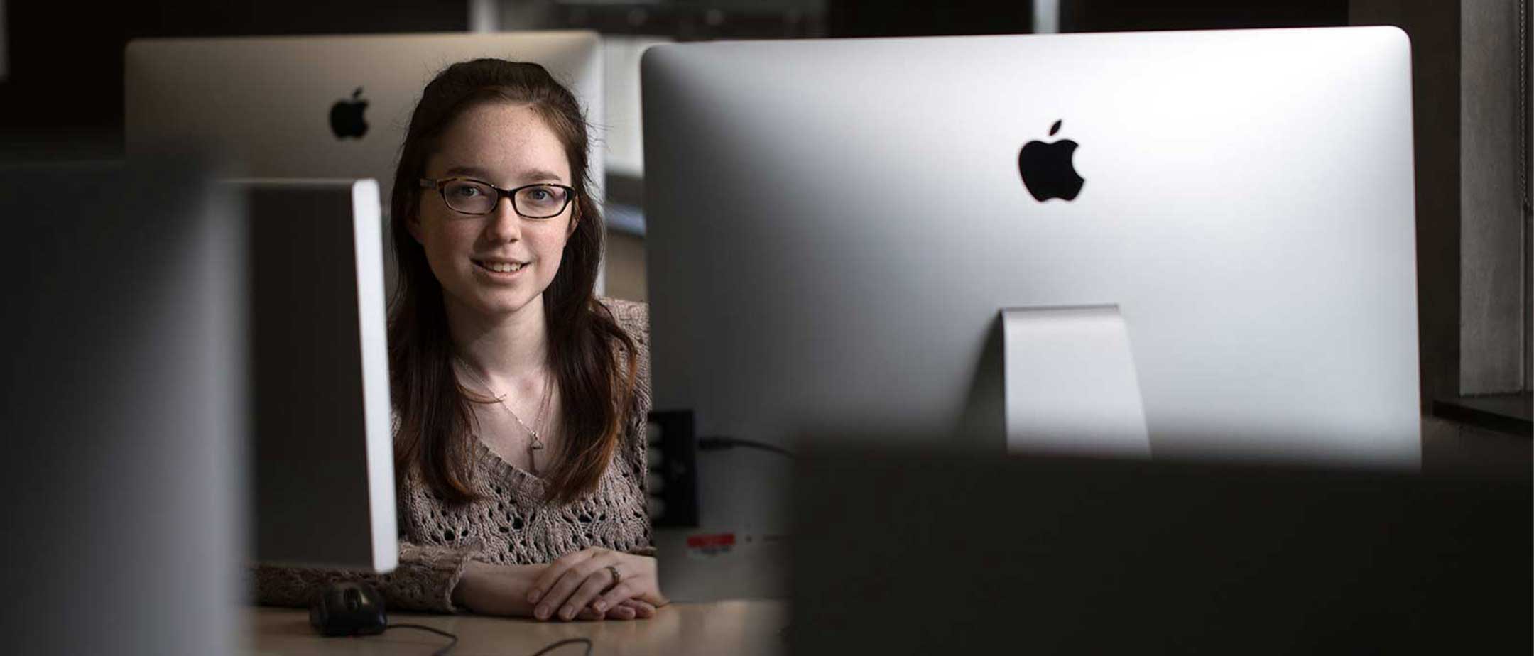 A student sitting in a computer lab