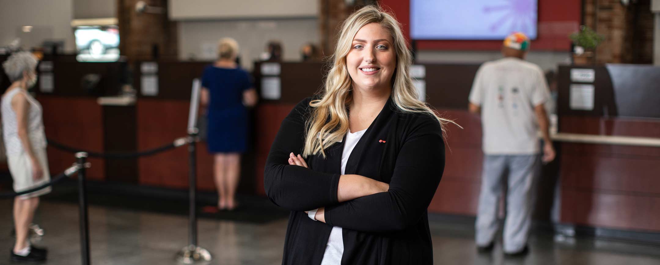 A graduate student standing in a bank