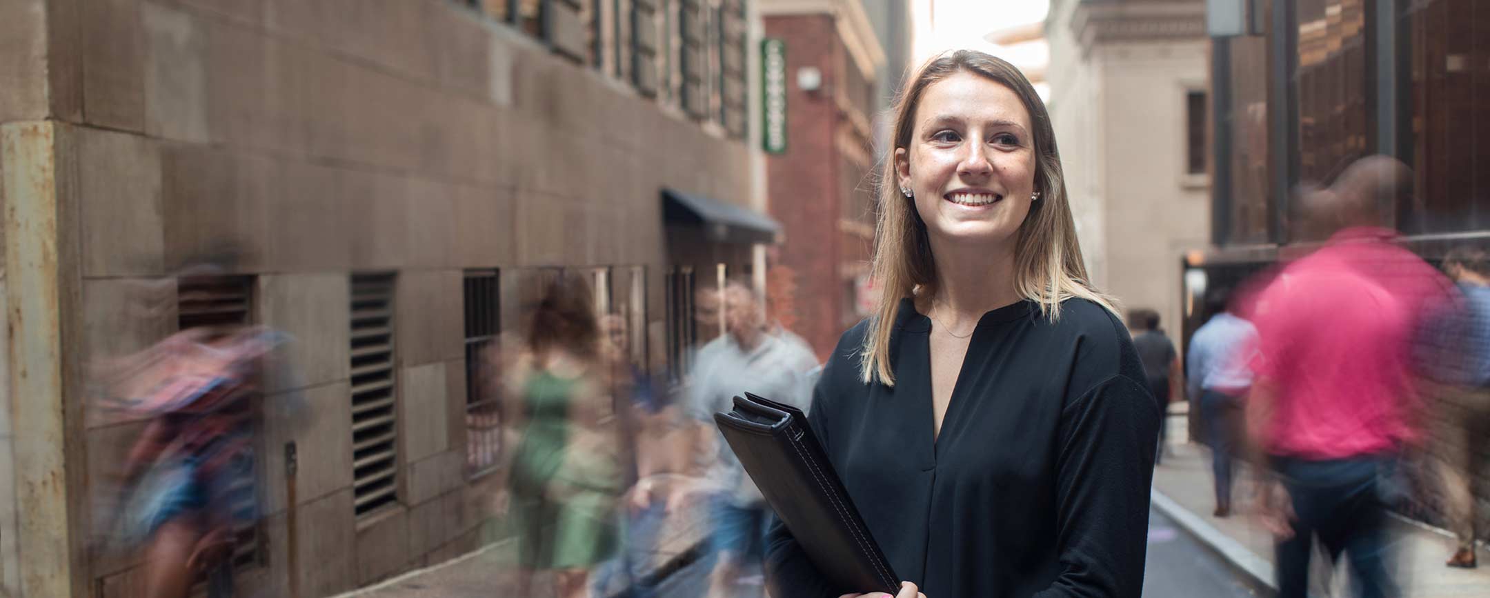 A business person standing in an alley