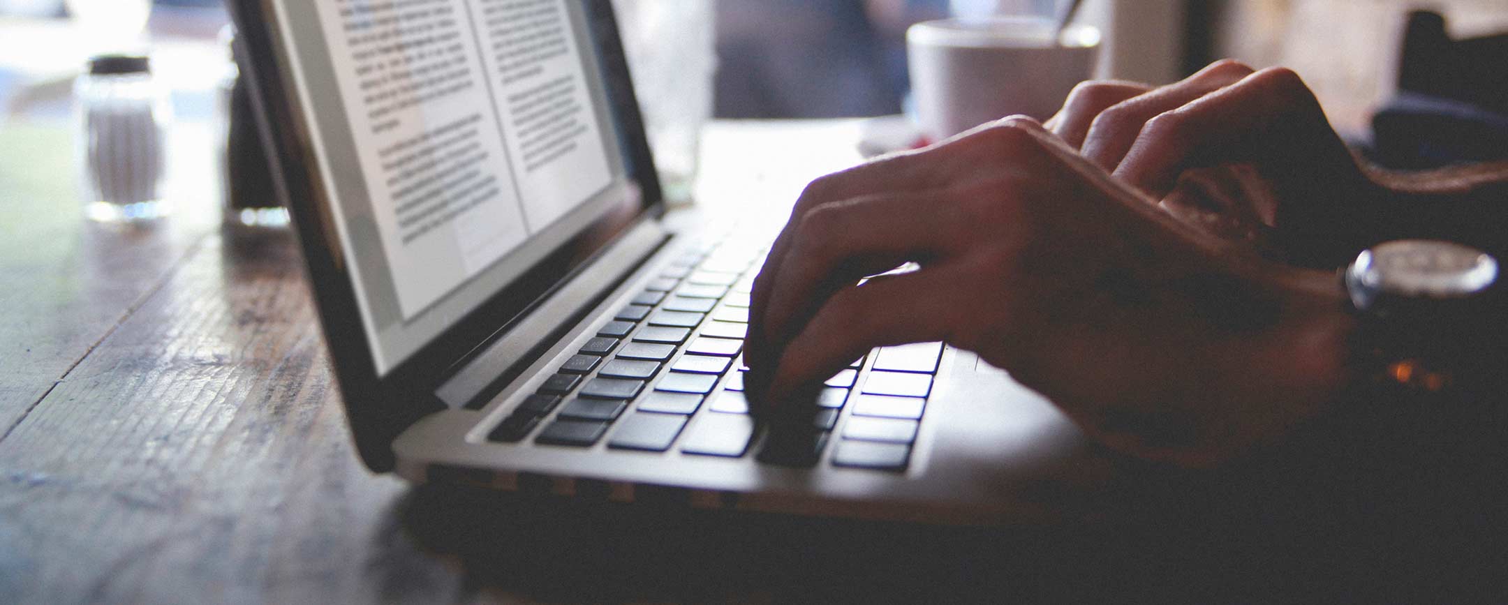 A creative writing certificate student using a laptop at PennWest. 