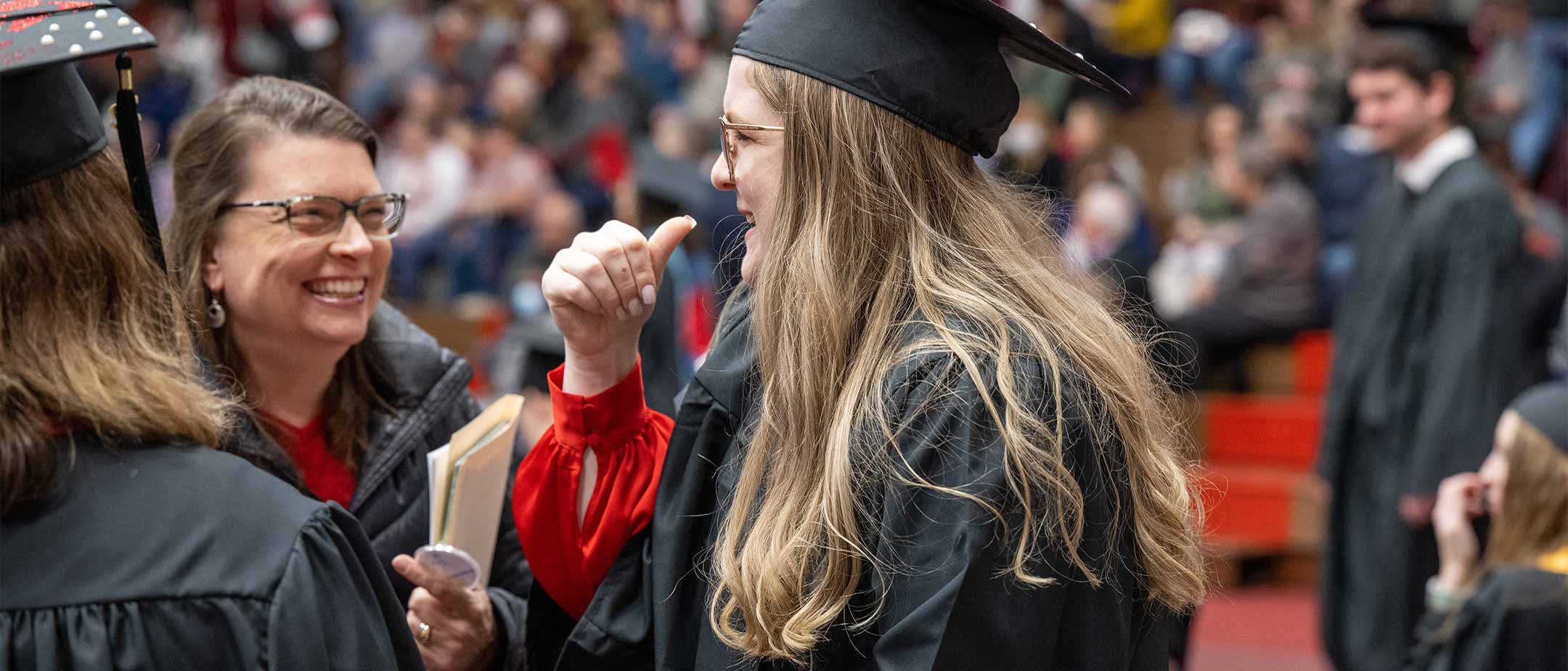 A deaf education signing at graduation