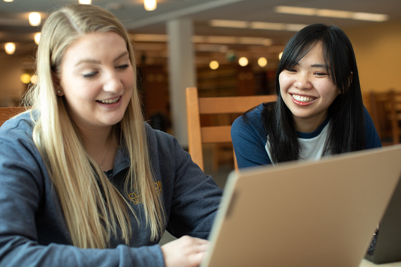 Students working together on a computer at PennWest Clarion. 