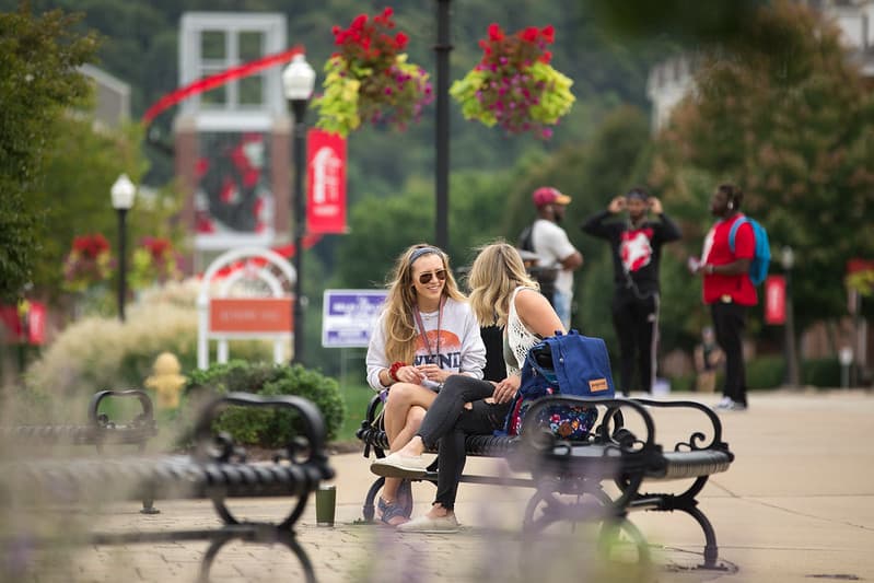 PennWest California students sitting on a bench.