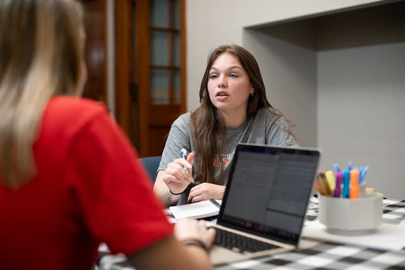 Two PennWest students using a computer. 