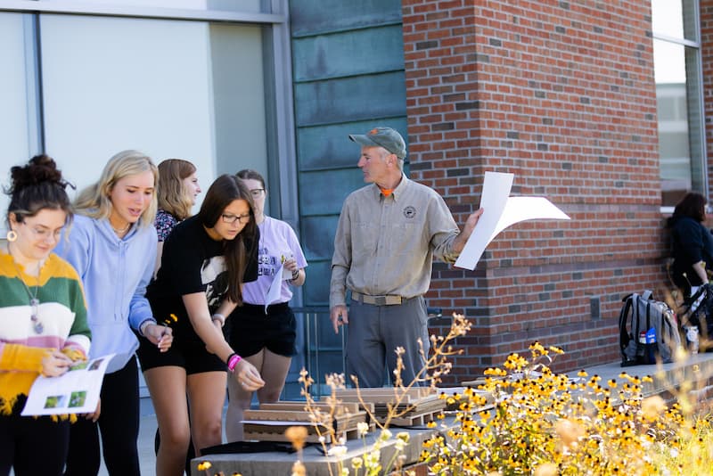 Students working outside with a professor at PennWest Clarion