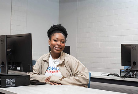 Student sitting behind computer desk