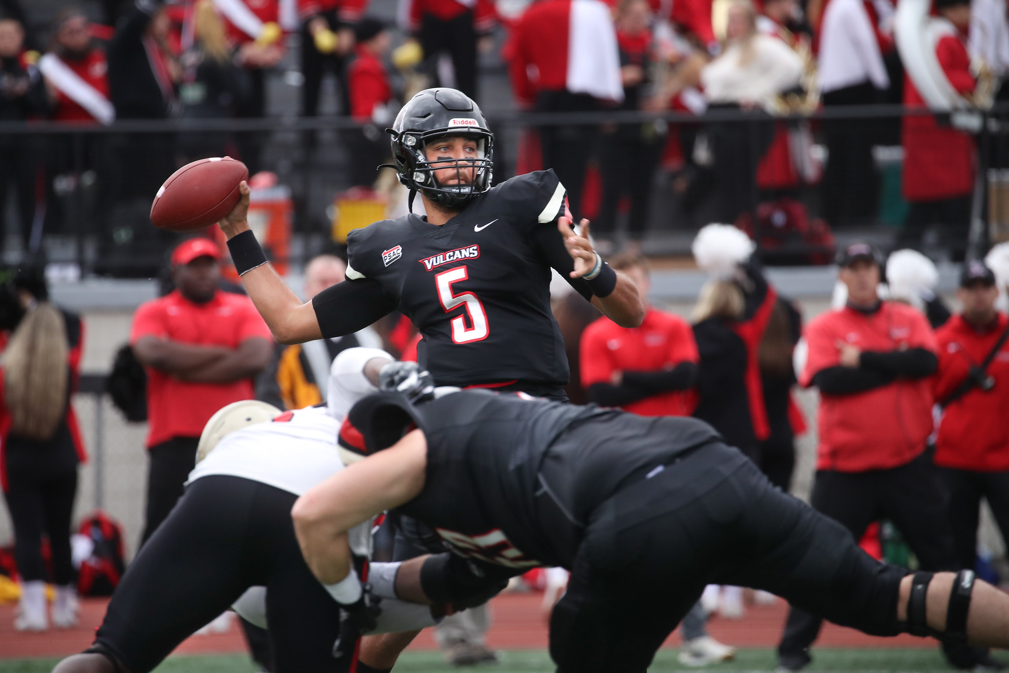 California football player makes a pass.