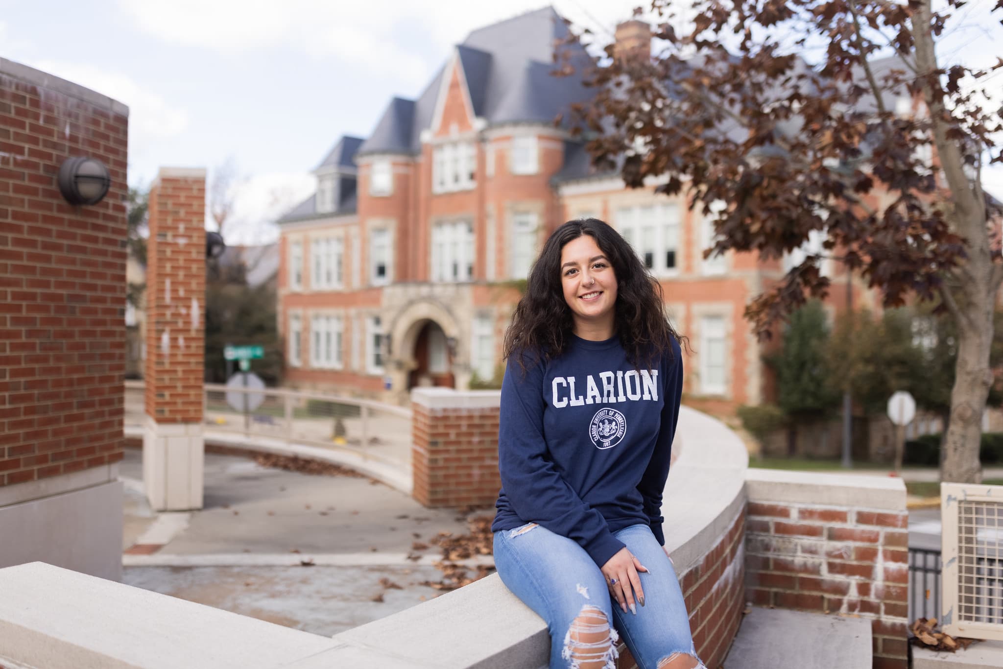 A student poses on PennWest Clarion's campus. 