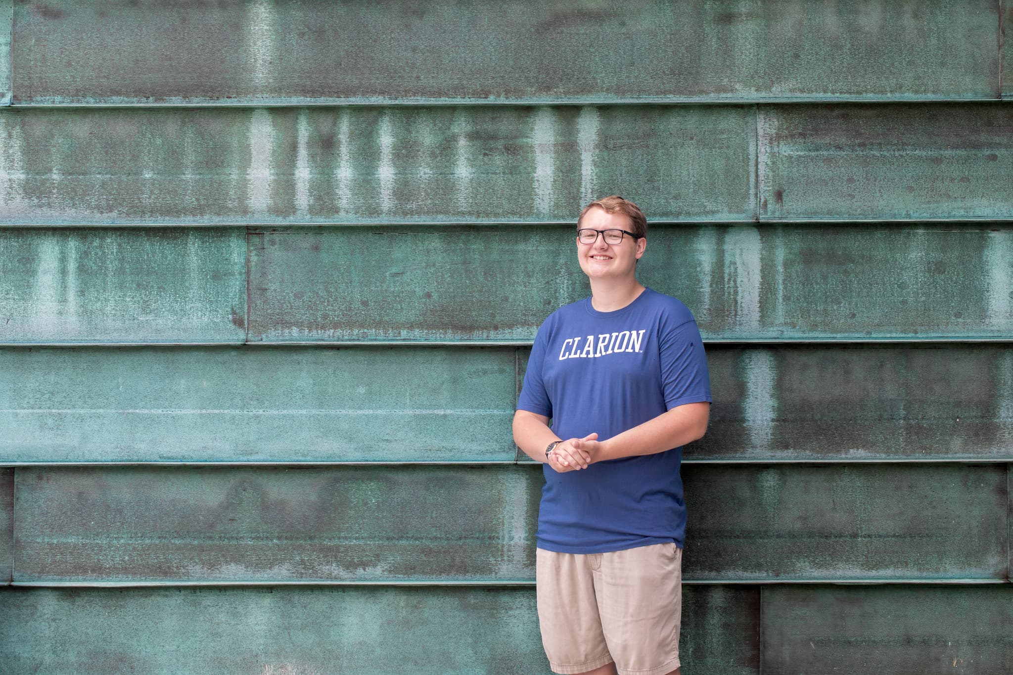 PennWest Clarion student standing in front of science center. 