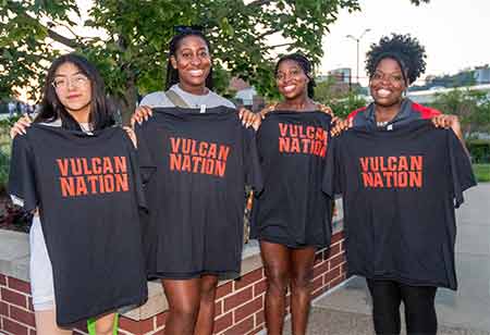 Students holding "Vulcan Nation" shirts