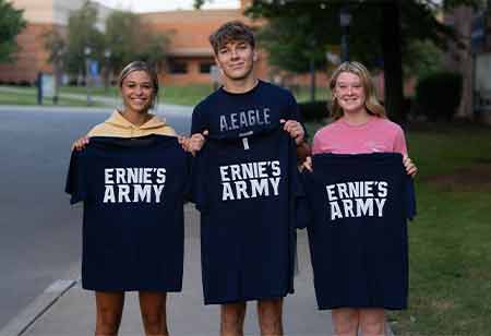 Students holding "Ernie's Army" shirts