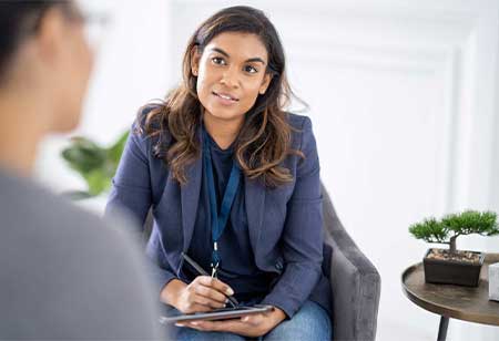 A psychologist taking notes during a session