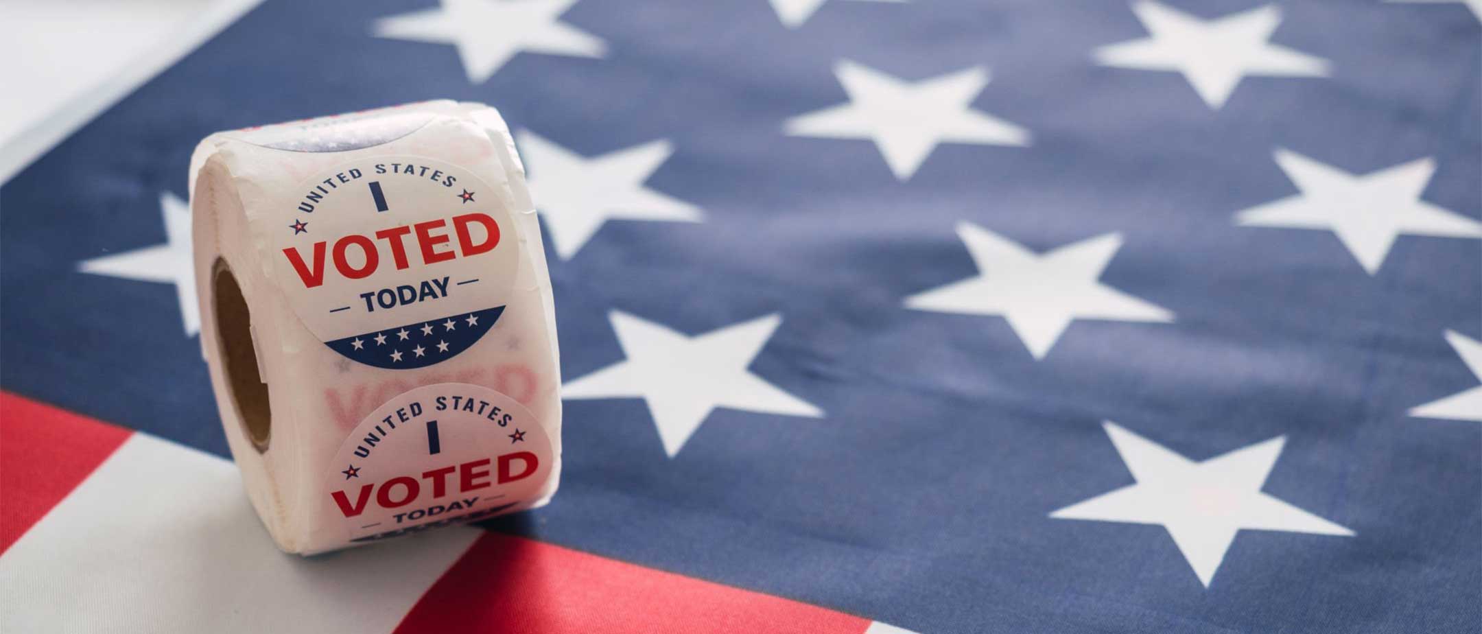 An american flag with a roll of "I Voted Today" stickers on it