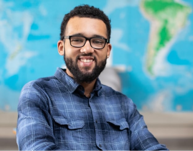 Student sitting in front of a world map