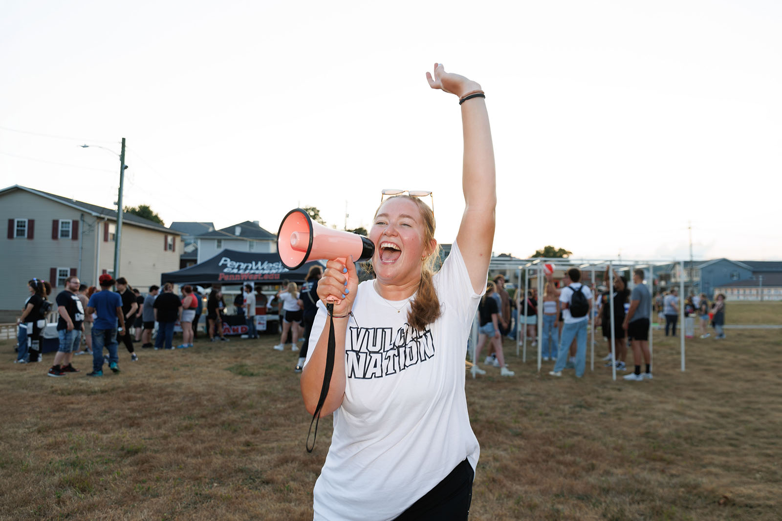 Caitlyn Egan welcomes students during a PennWest California campus event.